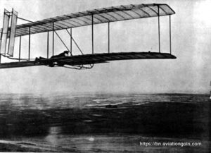 One of the successful glides made in October 1902 with the 1902 glider camp buildings in distance One of the successful glides made in October 1902 with the 1902 glider, camp buildings in distance